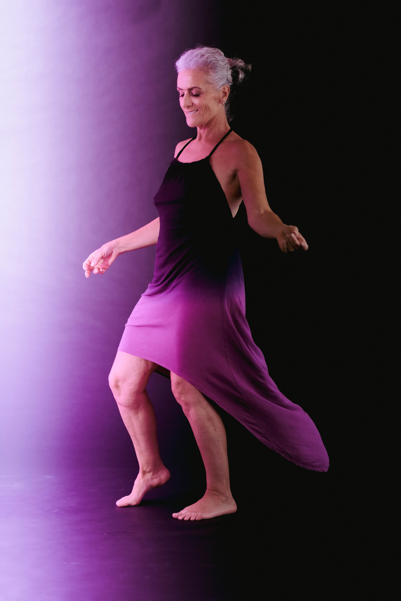 Emmanuelle dancing barefoot in a purple ombré dress